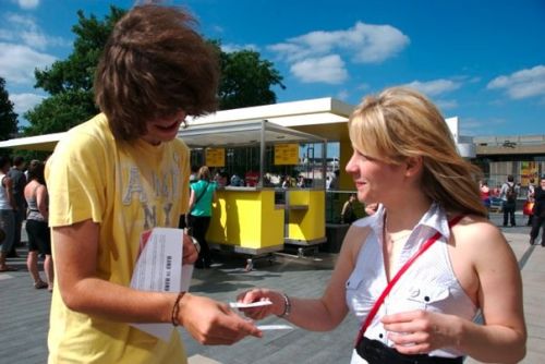 Two players exchange cards in the sun.