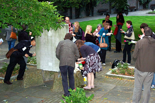 Players gathered around food in a park, talking to each other