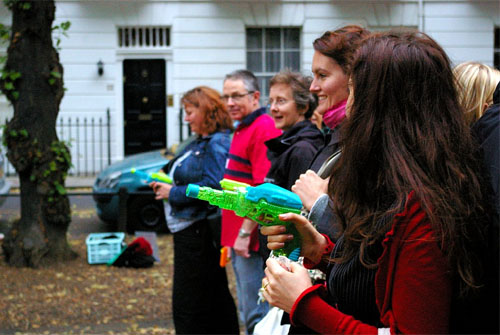 A line of players with water-pistols poised and ready to use